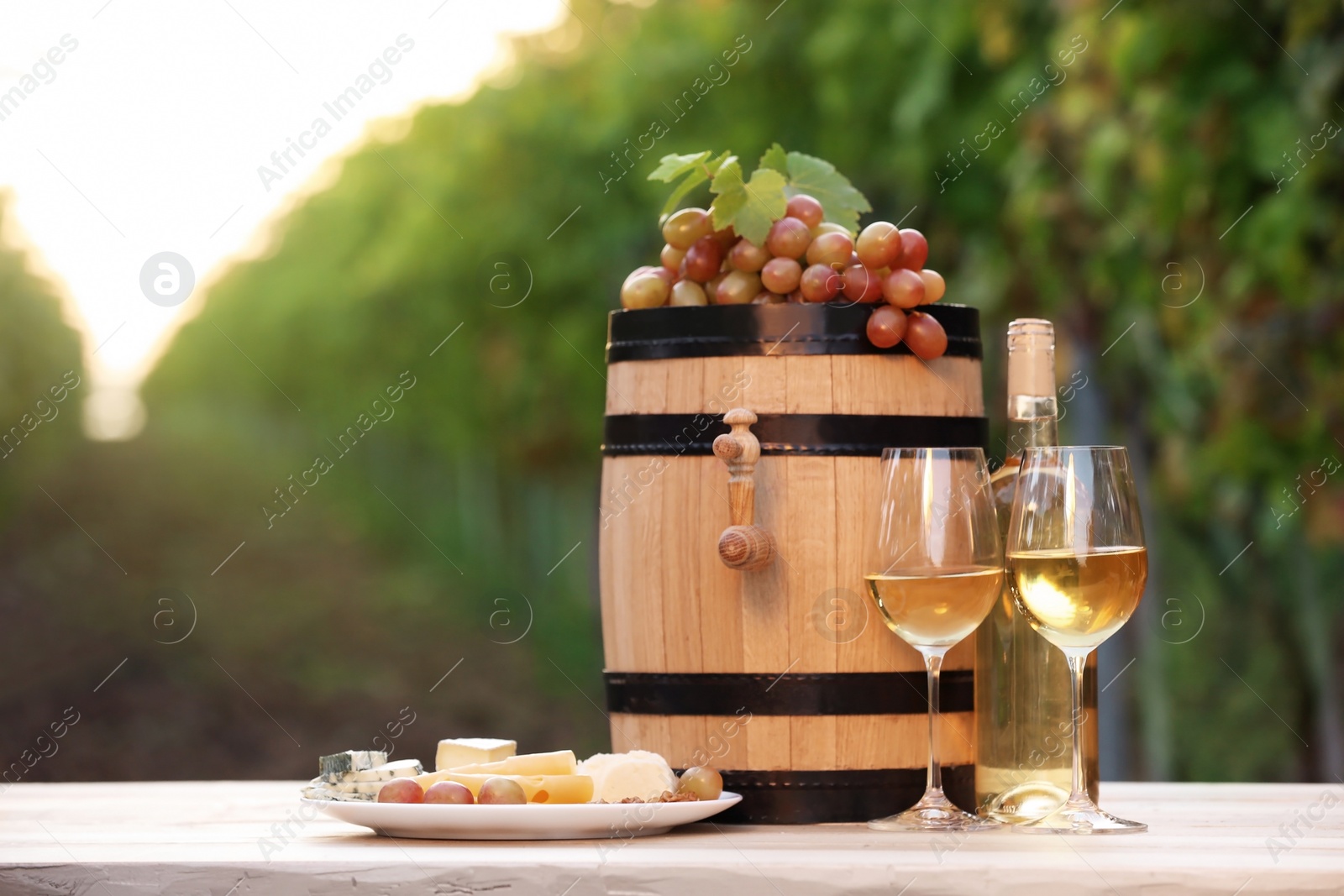 Photo of Composition with wine and snacks on table outdoors