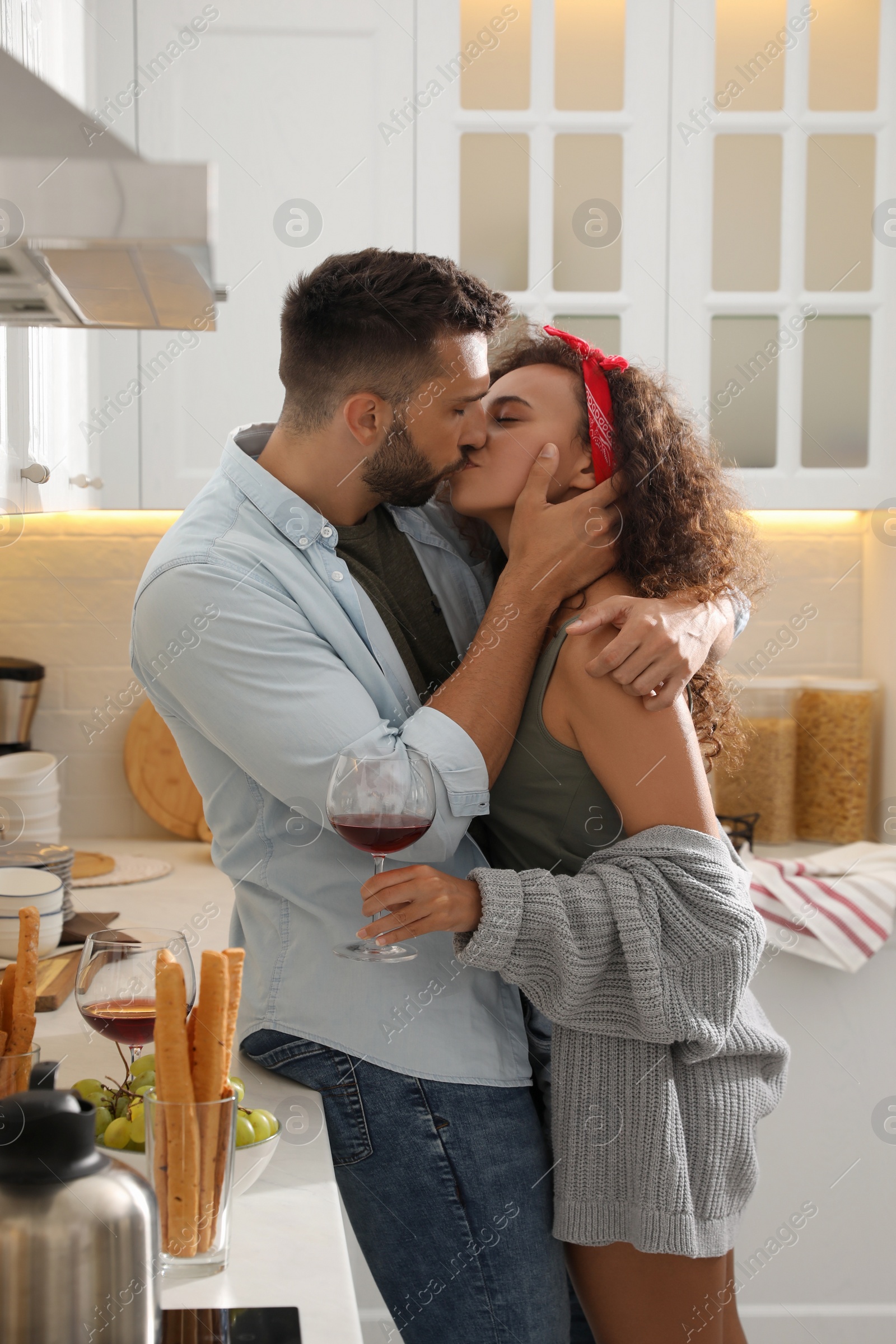 Photo of Lovely couple enjoying time together during romantic dinner in kitchen