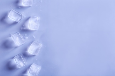 Ice cubes on color background, top view. Space for text