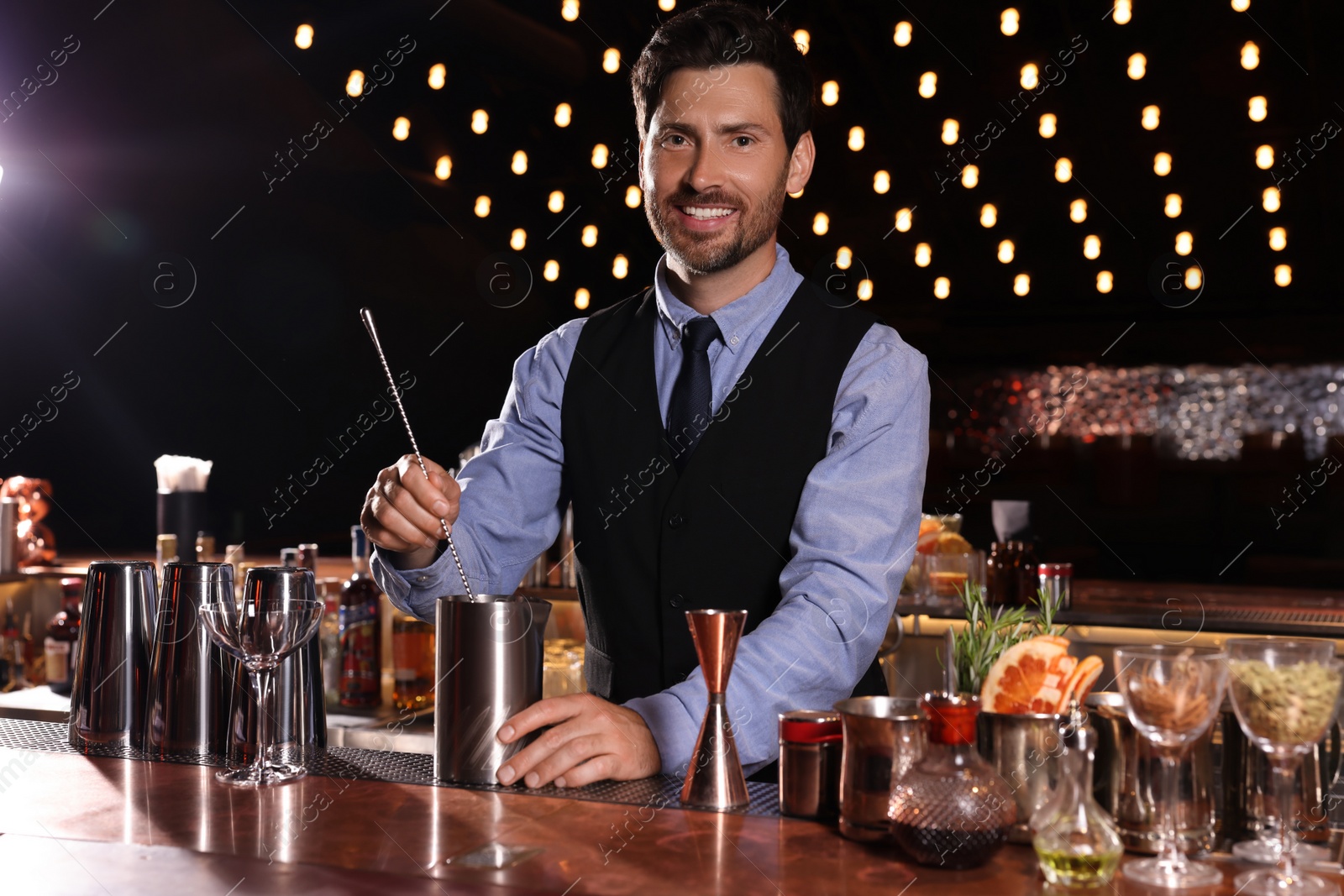 Photo of Bartender preparing fresh alcoholic cocktail in bar