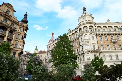 Photo of PRAGUE, CZECH REPUBLIC - APRIL 25, 2019: Beautiful buildings on city street. low angle view