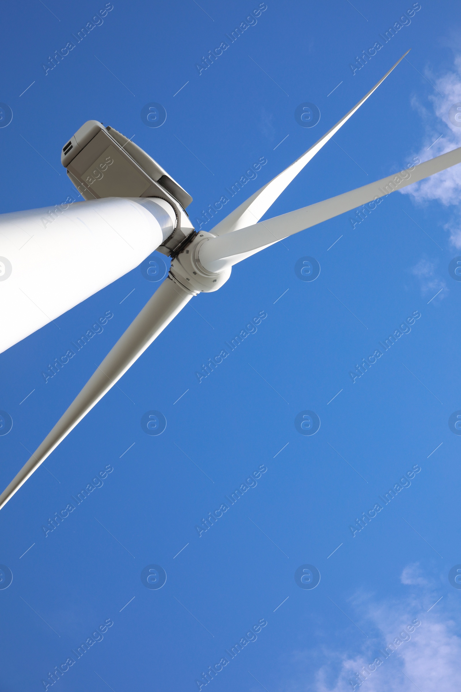 Photo of Wind turbine against beautiful blue sky, low angle view. Alternative energy source