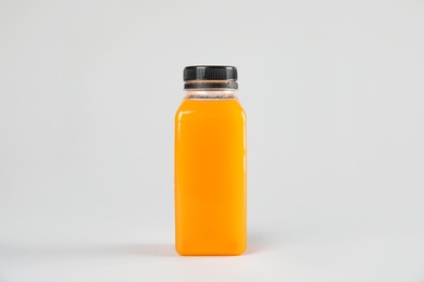 Photo of One bottle with tasty drink on color background