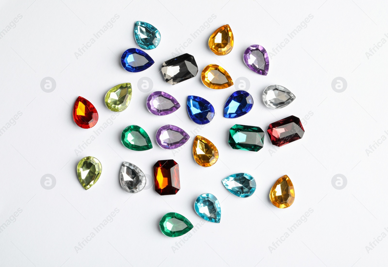 Image of Different beautiful gemstones on white background, top view