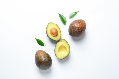 Composition with ripe fresh avocados on white background