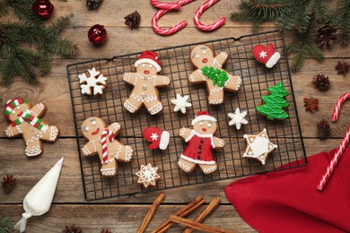 Delicious Christmas cookies and festive decor on wooden table, flat lay