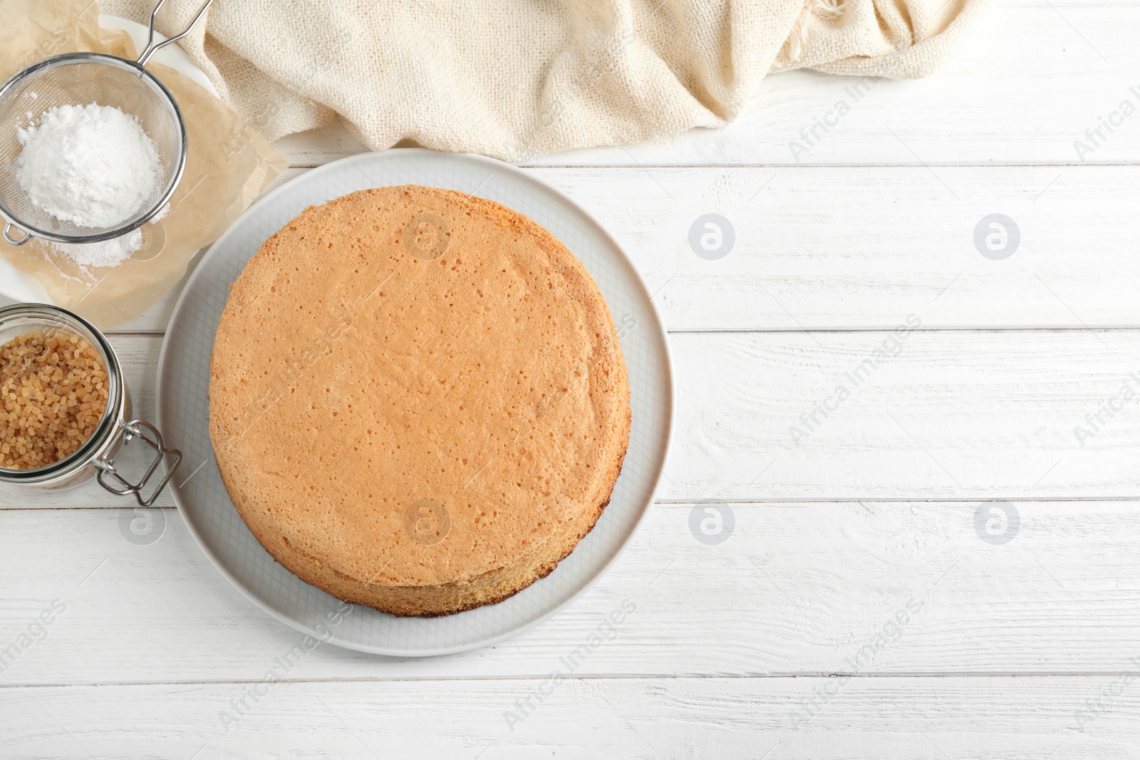 Photo of Flat lay composition with delicious fresh homemade cake on white wooden table. Space for text