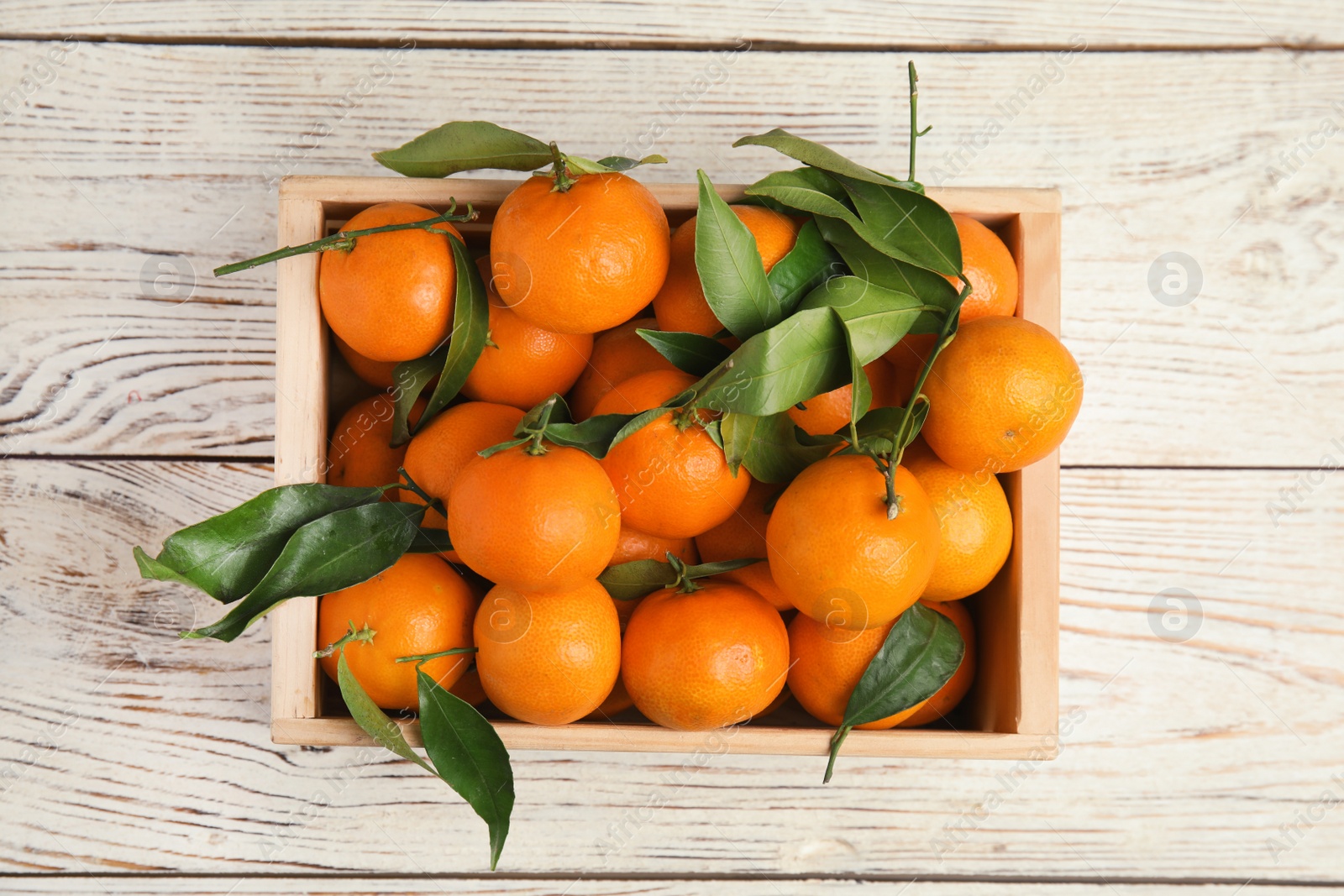 Photo of Crate with fresh ripe tangerines on wooden background, top view