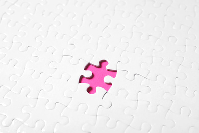 Photo of Blank white puzzle with missing piece on pink background