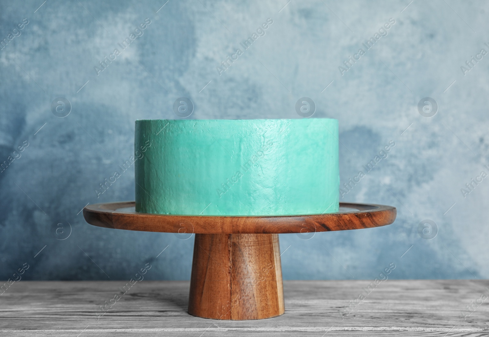 Photo of Fresh delicious birthday cake on stand against color background