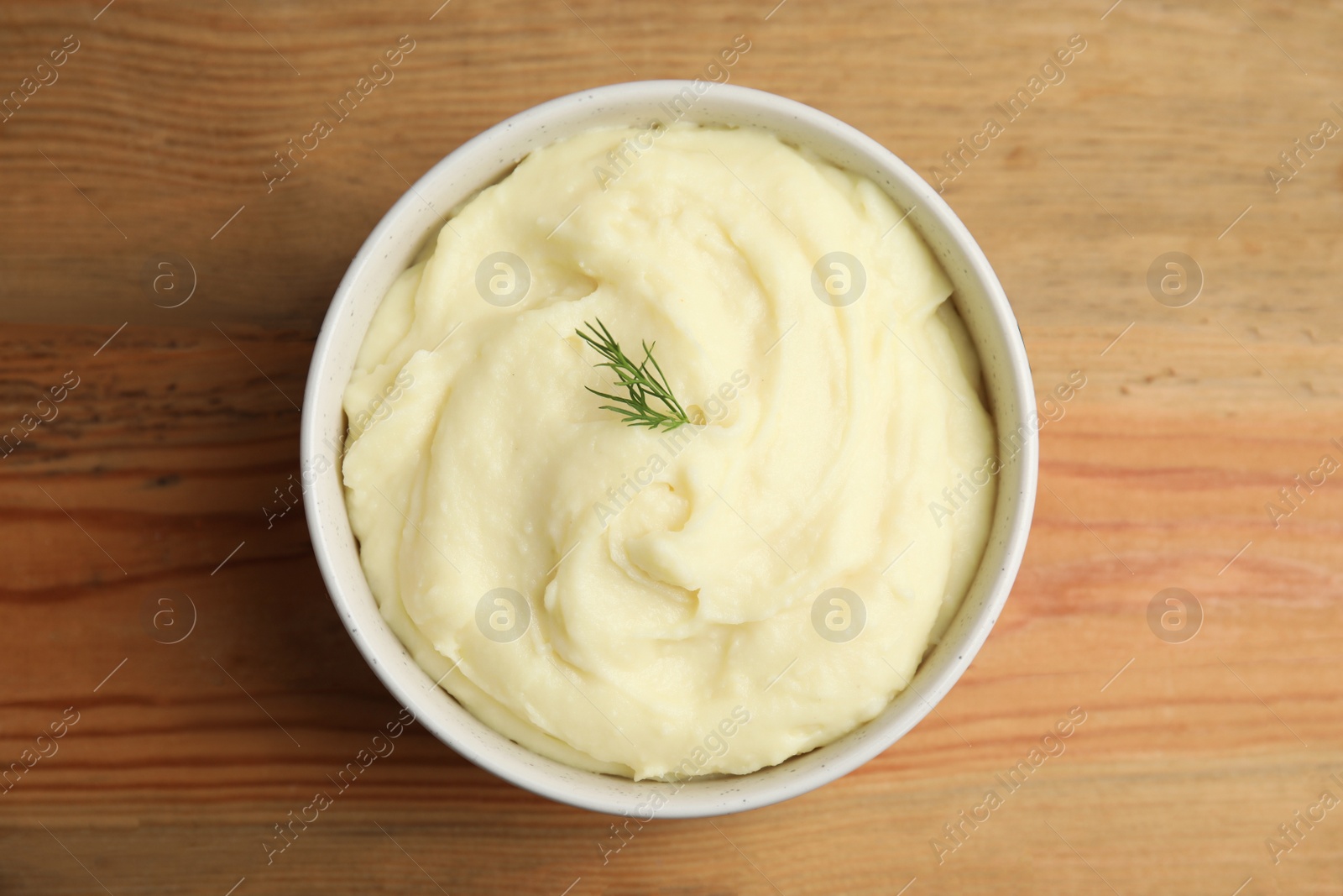 Photo of Freshly cooked homemade mashed potatoes on wooden table, top view