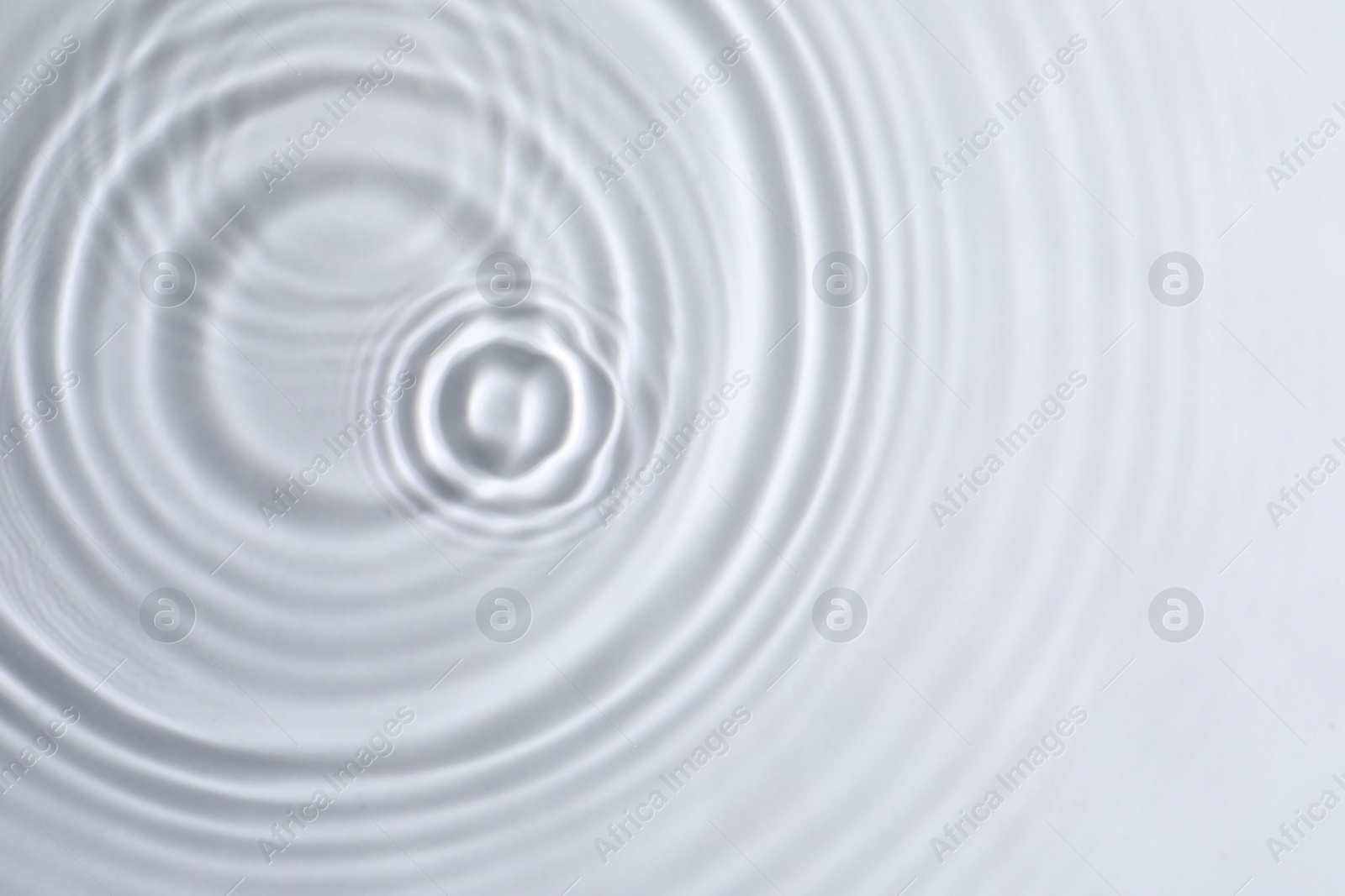 Photo of Closeup view of water with circles on light background