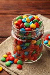 Photo of Tasty colorful candies on wooden table, closeup