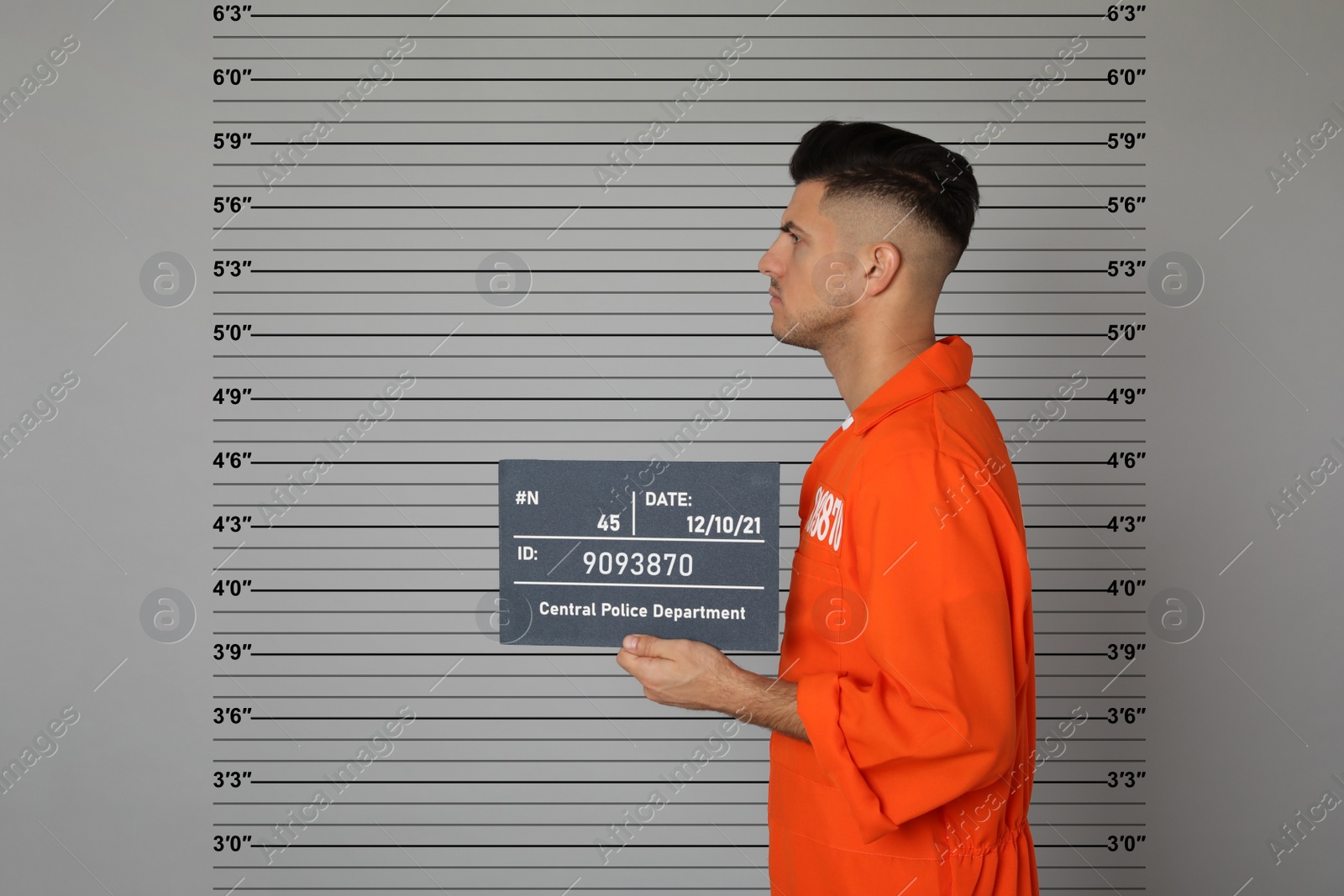 Image of Prisoner with mugshot letter board at police department