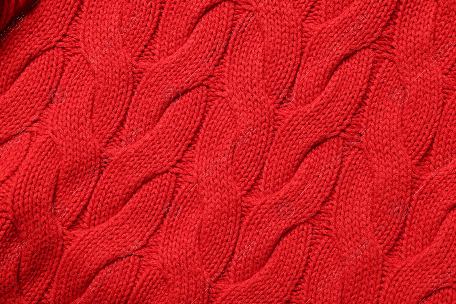 Photo of Texture of soft red knitted fabric as background, top view