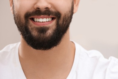 Photo of Happy young man with white teeth, closeup