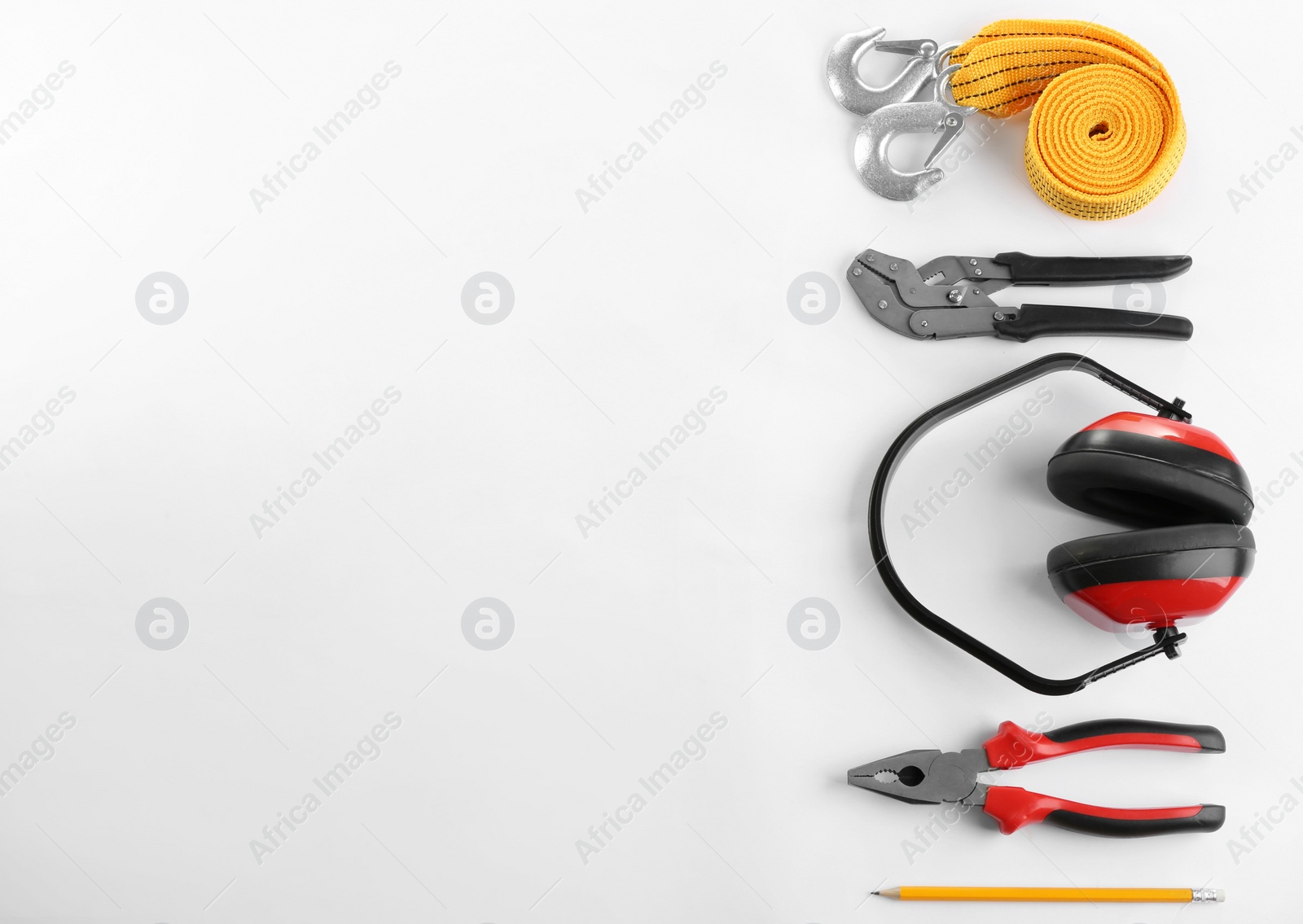 Photo of Flat lay composition with construction tools and safety equipment on white background. Space for text