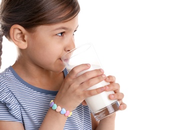 Photo of Cute little girl drinking milk on white background