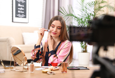 Beauty blogger recording makeup tutorial at home