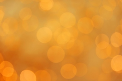 Gold glitter with bokeh effect on light background