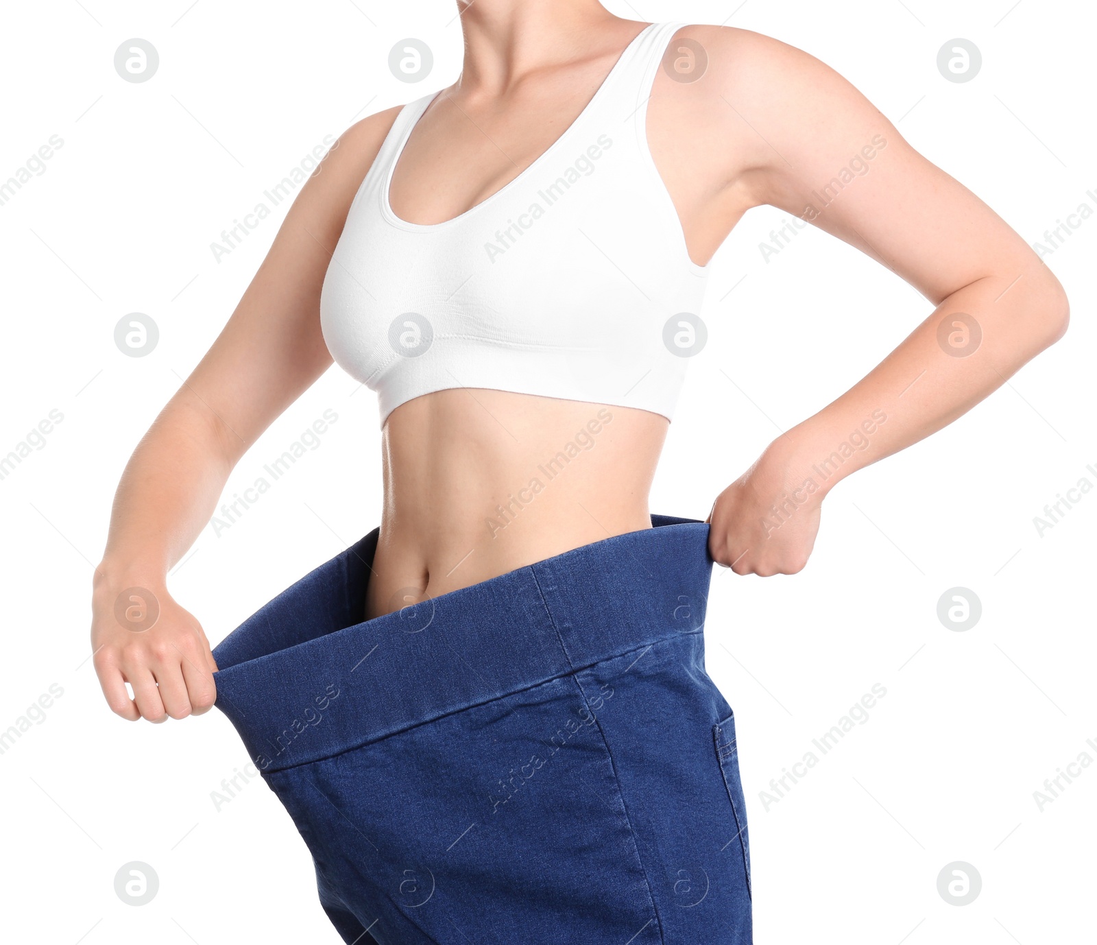 Photo of Young slim woman wearing oversized jeans on white background, closeup