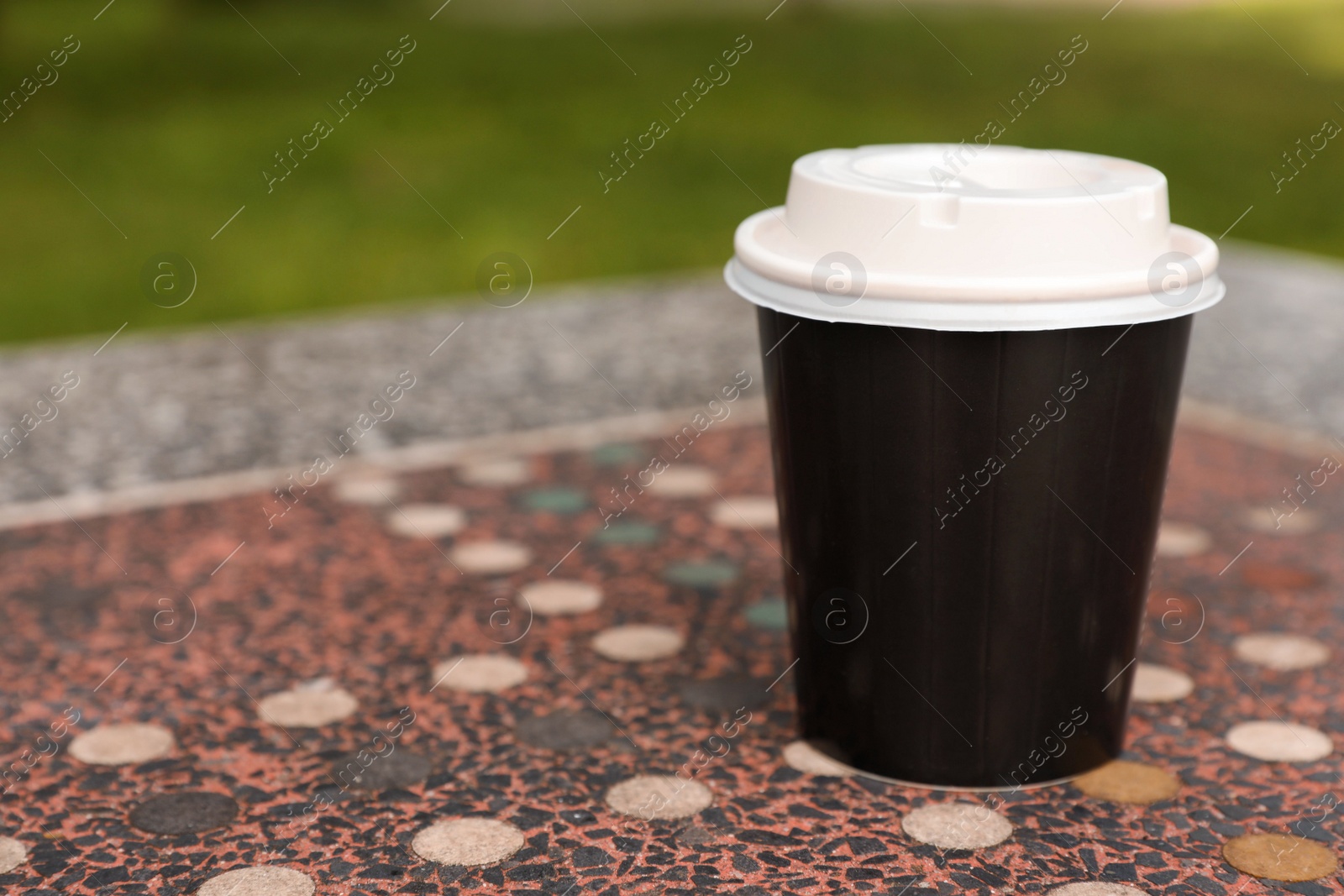 Photo of Paper cup on parapet table, space for text. Coffee to go