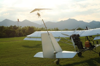 Photo of Modern white airplane on green grass outdoors