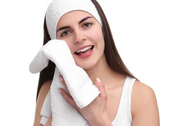 Photo of Washing face. Young woman with headband and towel on white background