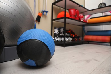 Photo of Different balls on floor in room with other sports equipment, space for text