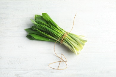 Bunch of wild garlic or ramson on white wooden table