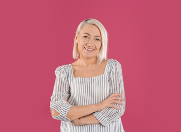 Photo of Portrait of beautiful mature woman on pink background