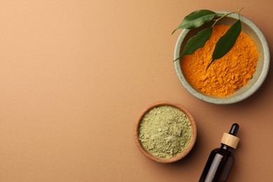 Photo of Flat lay composition with henna and turmeric powder on coral background, space for text. Natural hair coloring