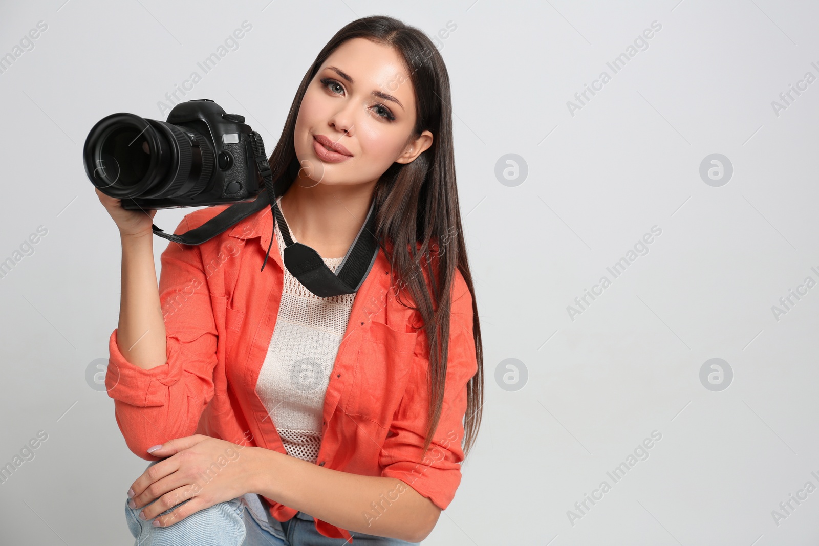 Photo of Professional photographer working on white background in studio