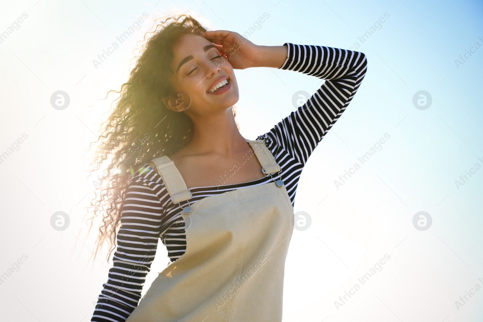 Photo of Beautiful young woman outdoors on sunny day. Summer trip