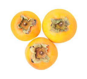 Whole delicious juicy persimmons on white background, top view