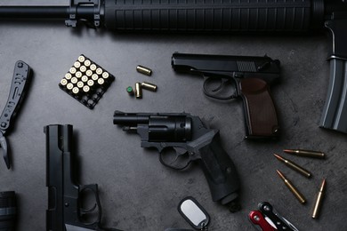 Photo of Flat lay composition with professional guns on black background