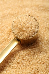 Photo of Scoop on granulated brown sugar, closeup view