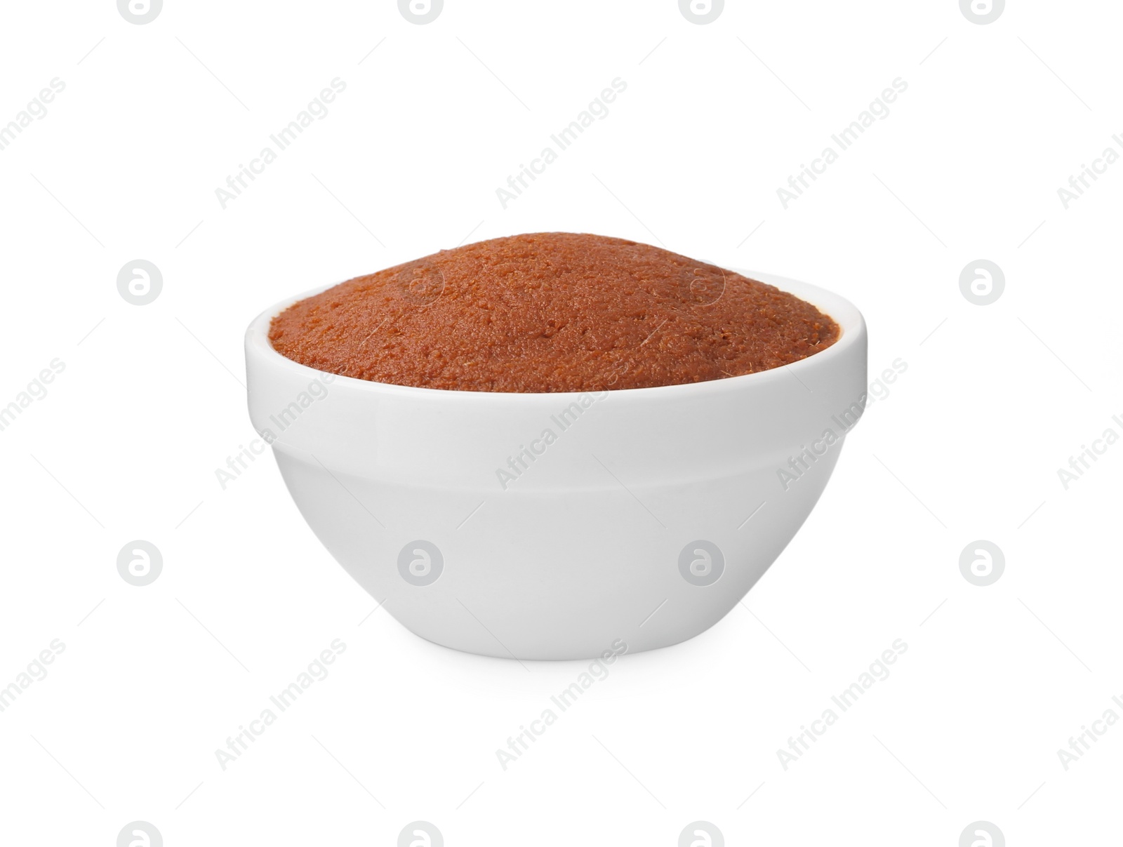 Photo of Tasty curry paste in bowl isolated on white