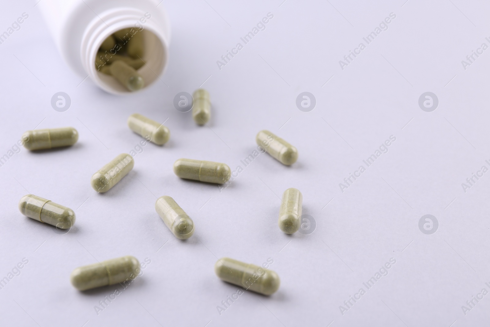 Photo of Jar with vitamin capsules on white background, closeup. Space for text