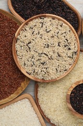 Dishes with different sorts of rice on table, flat lay