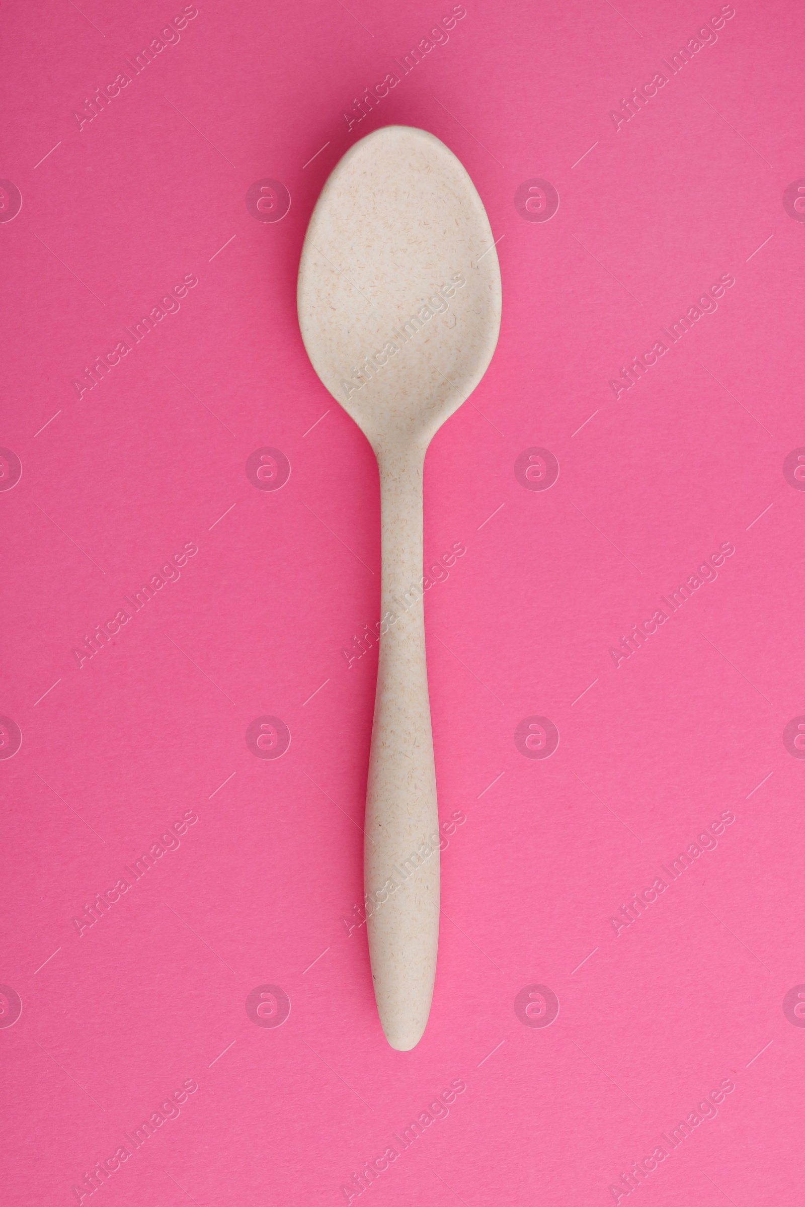 Photo of Clean spoon on color background, top view