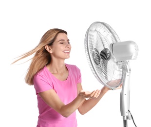 Photo of Woman refreshing from heat in front of fan on white background