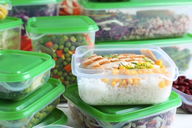 Photo of Set of plastic containers with fresh food on table