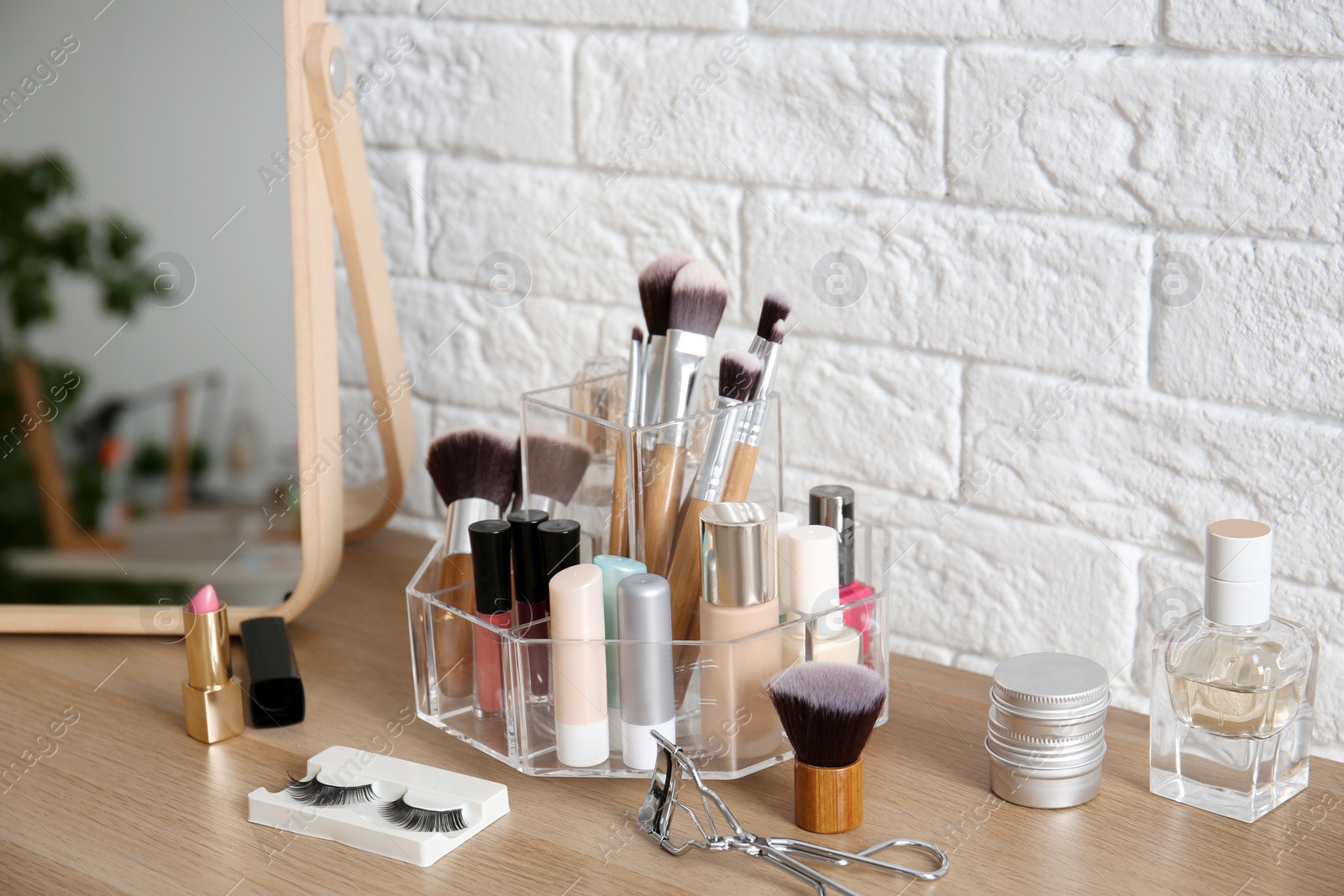 Photo of Makeup cosmetic products and tools on dressing table