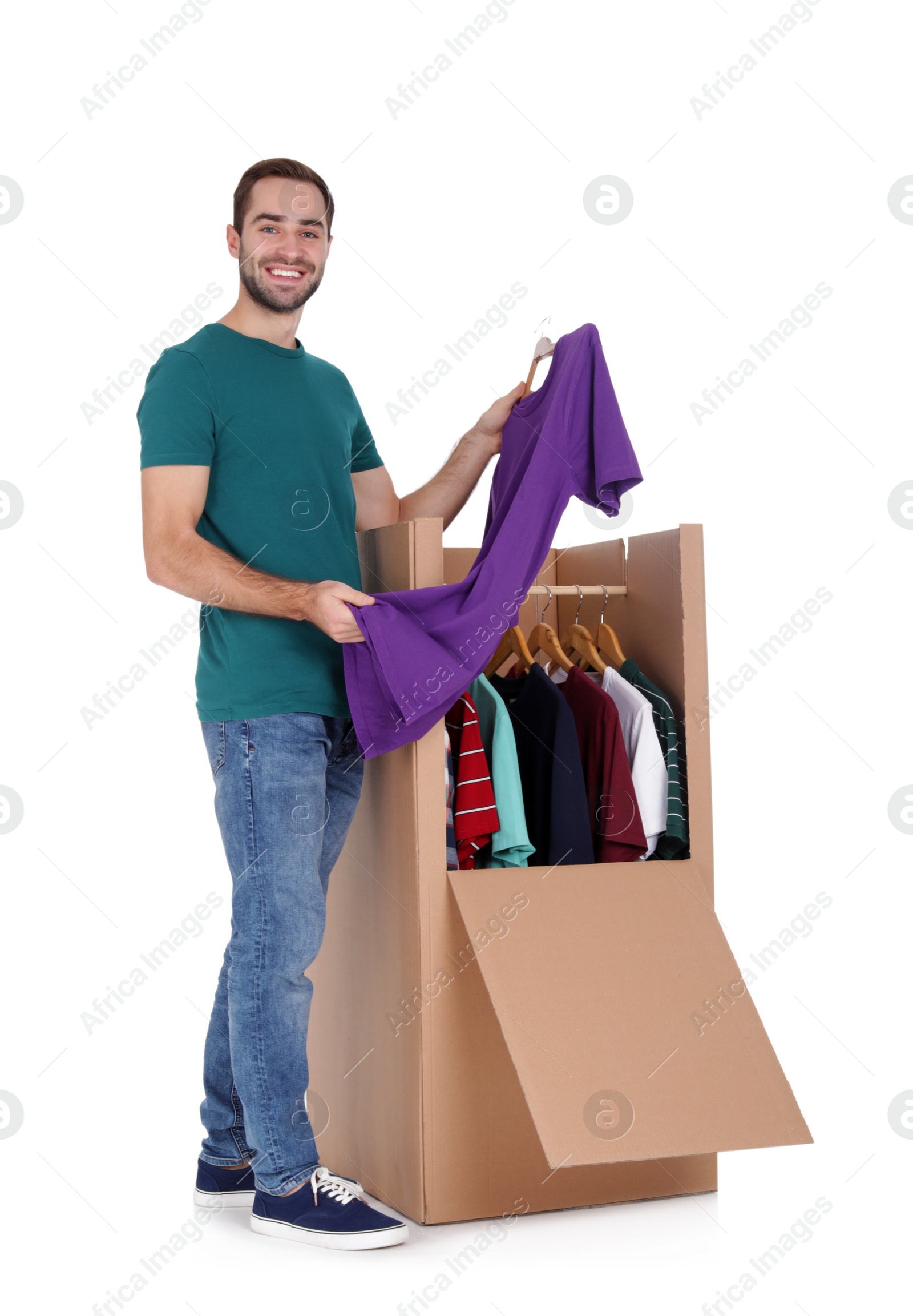 Photo of Young man near wardrobe box on white background