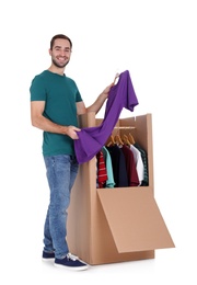 Young man near wardrobe box on white background