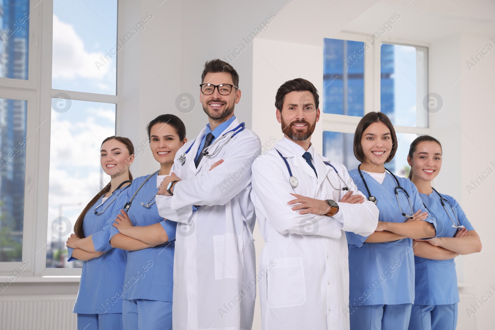 Photo of Team of professional doctors in clinic hallway