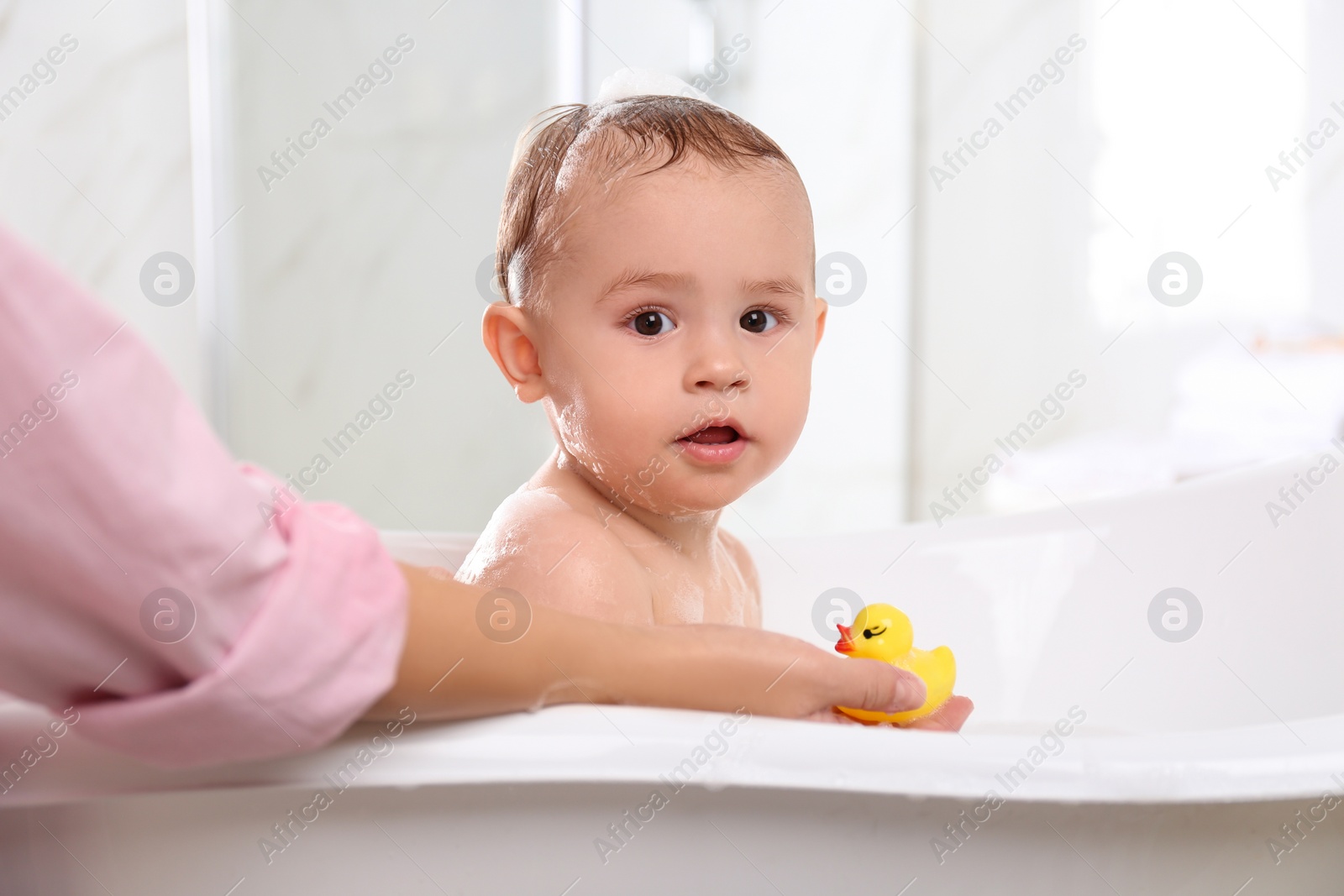 Photo of Mother with her little baby in bathroom