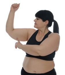 Obese woman with flabby arm on white background. Weight loss surgery