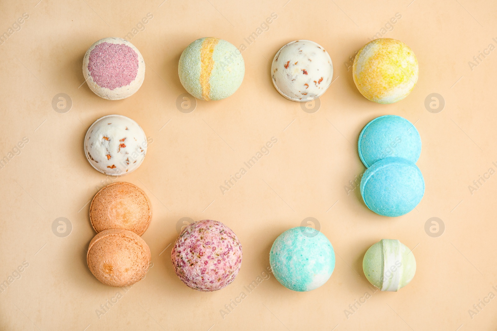 Photo of Flat lay composition with bath bombs and space for text on color background